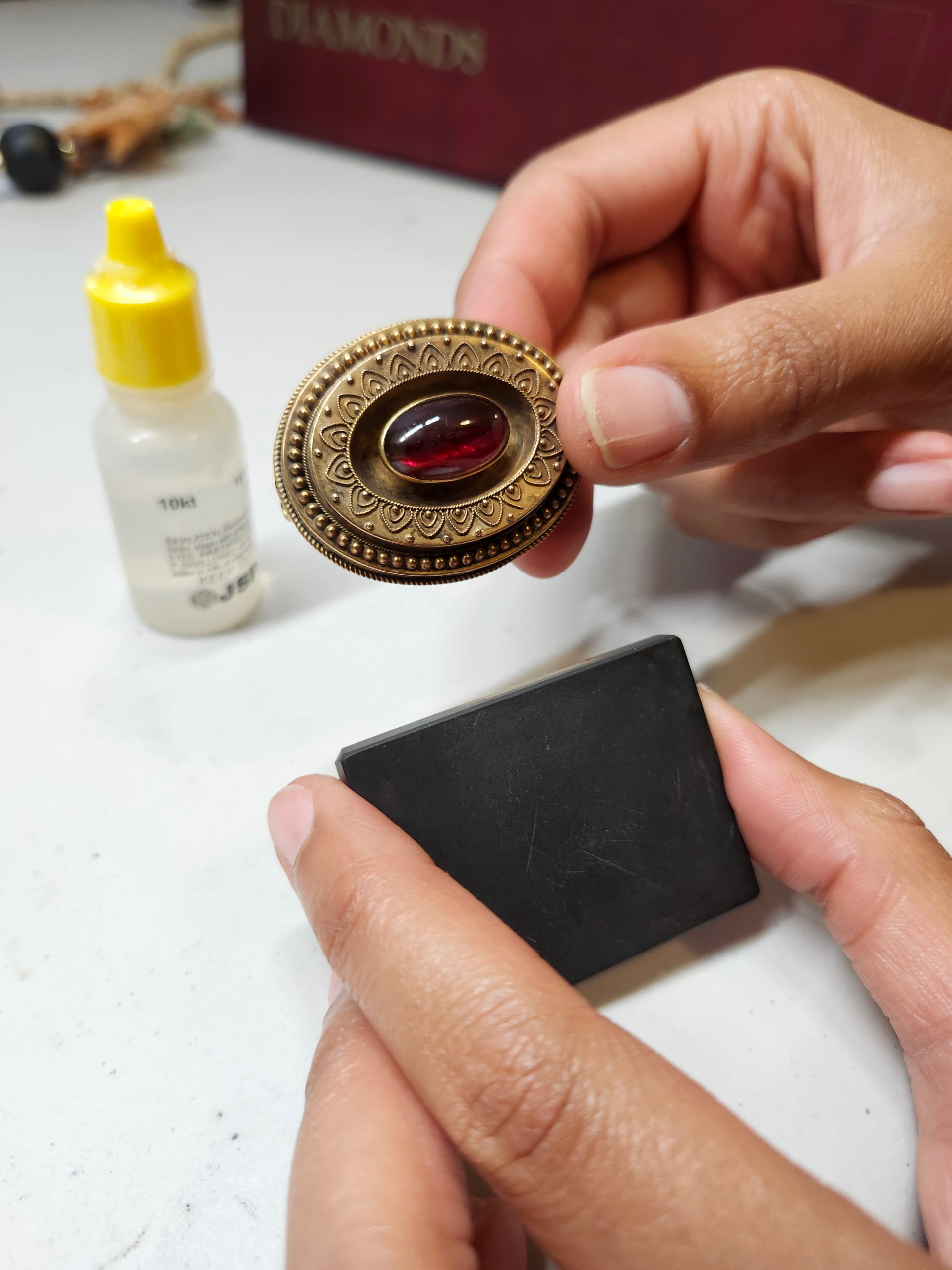 Testing an Antique Gold Brooch with Acid and a Touchstone